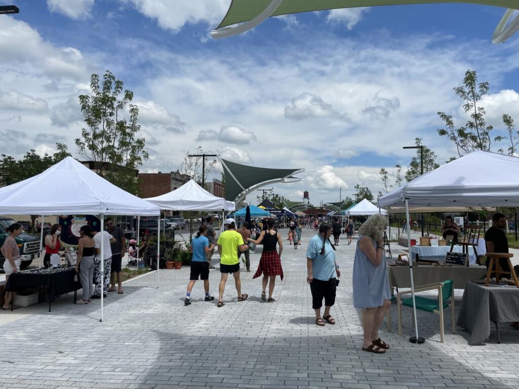 a crowd of people at an outdoor market.