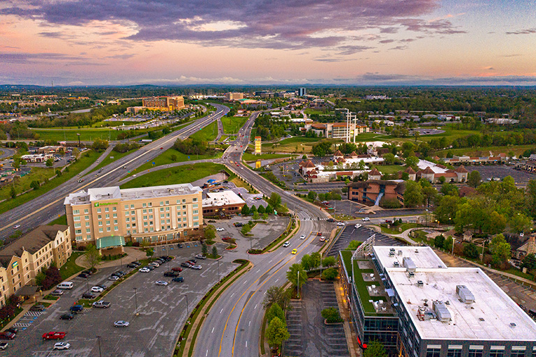 an aerial view of a city at dusk.