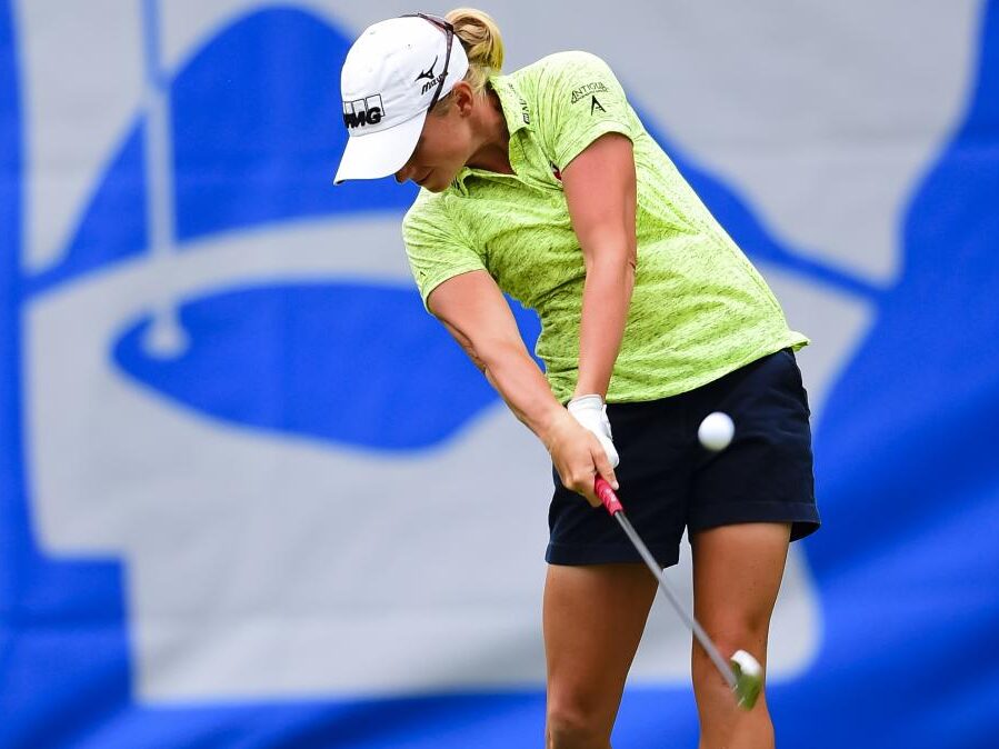 Women golfer hitting golf ball