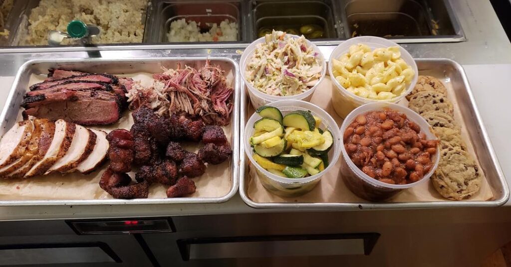 a tray of meats and vegetables on a counter.