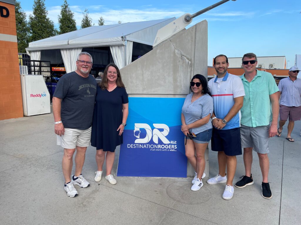 A group of people standing in front of a sign that says dr.