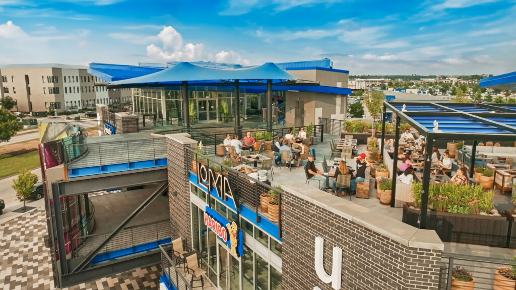 An aerial view of a restaurant with people sitting outside.