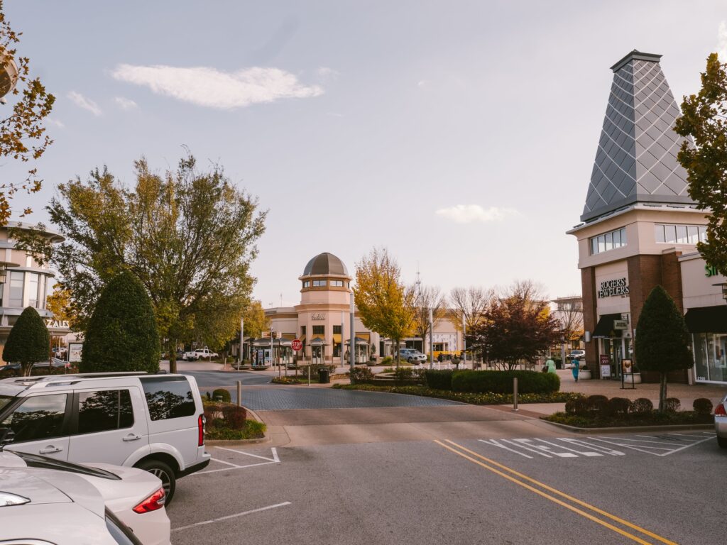 a street with cars parked in front of a clock tower.