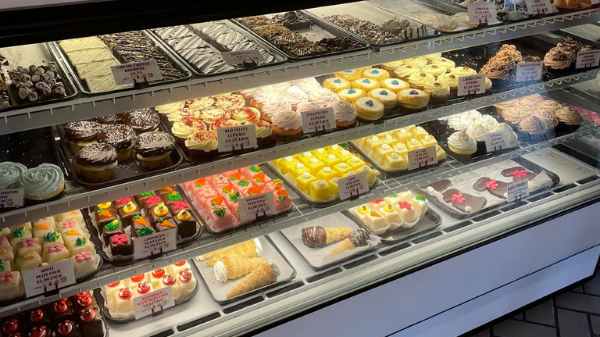 a bakery case filled with a variety of pastries.