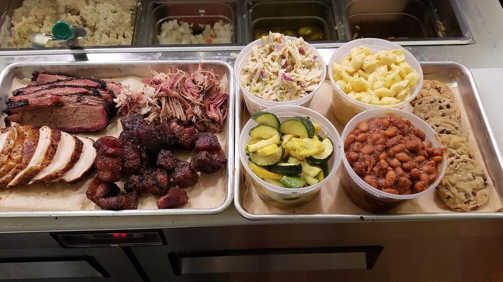 a tray of meats and vegetables on a counter.