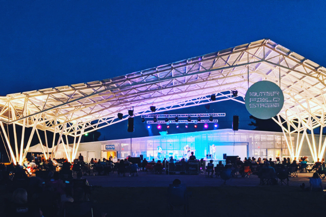 a large outdoor concert venue lit up at night.