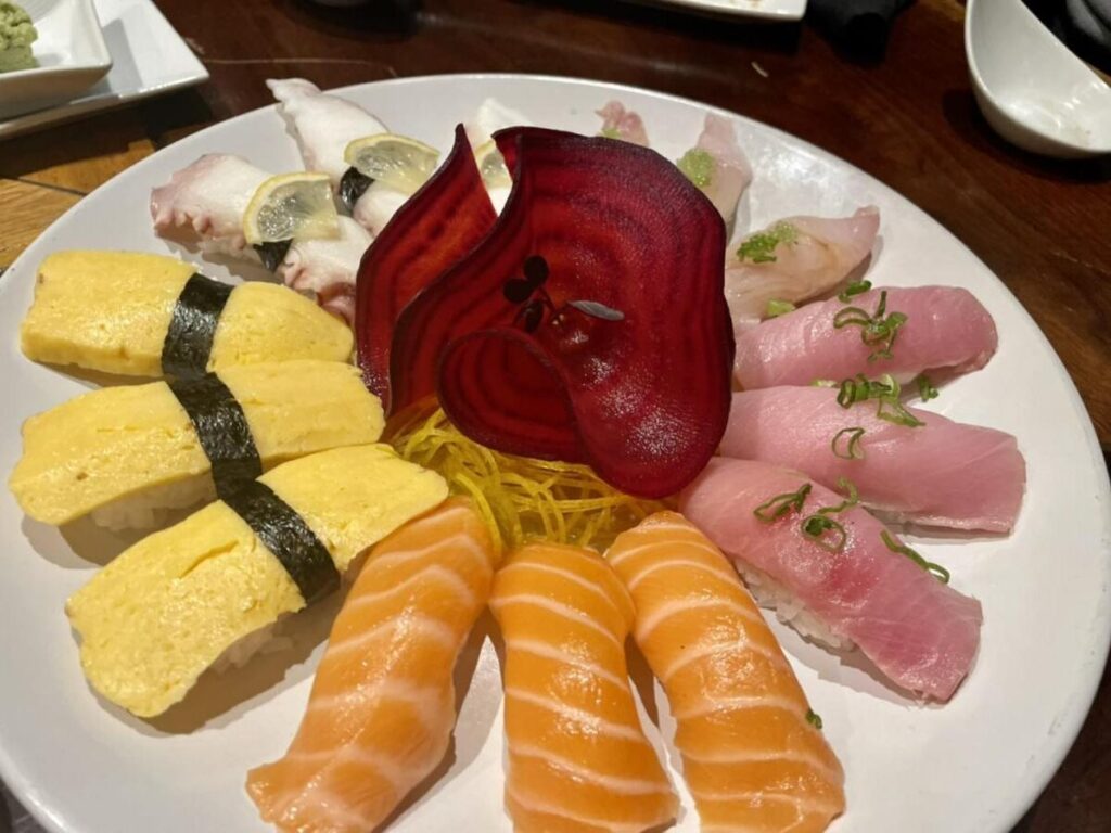 a plate with a variety of sushi on it.