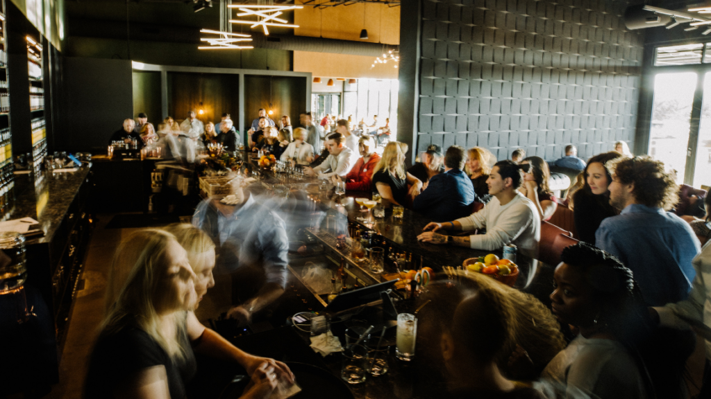 a crowd of people at a bar.