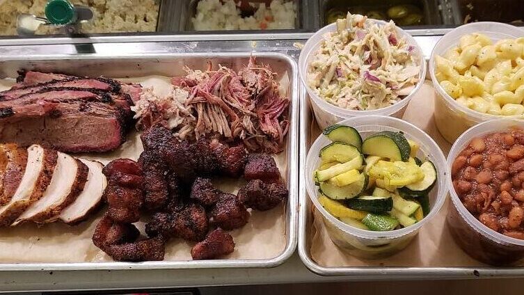 a tray of meats and vegetables on a counter.