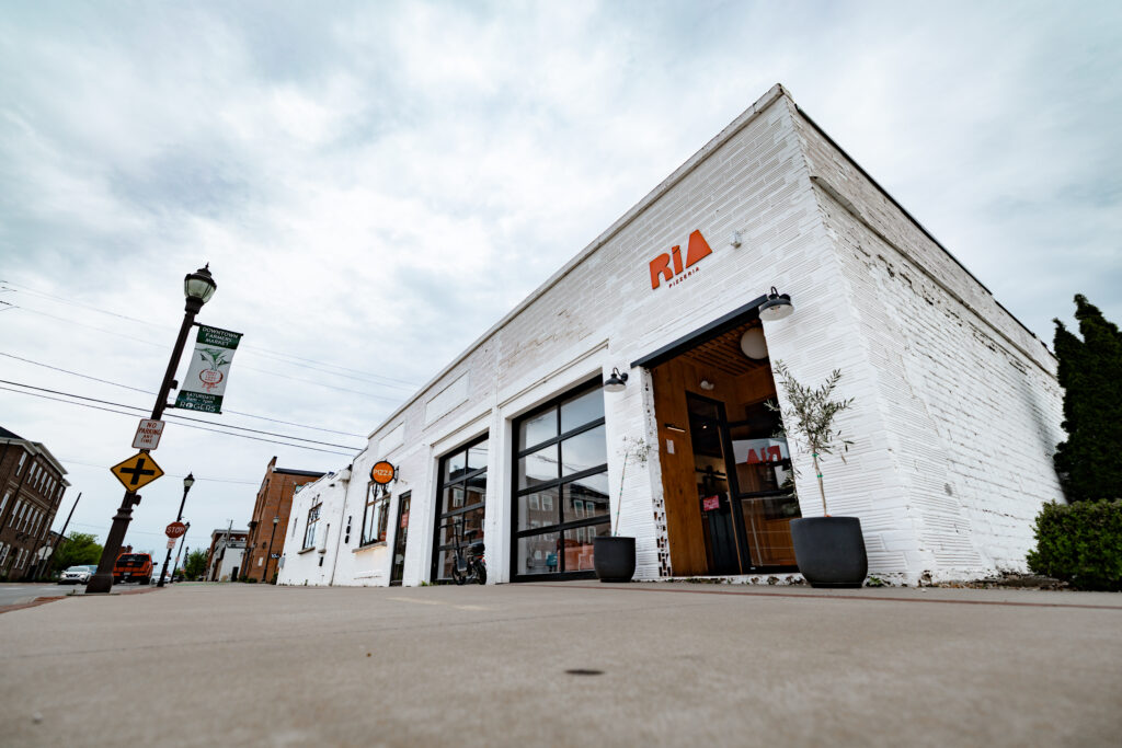 Exterior of Ria Pizzeria shot from along the Razorback Greenway.
