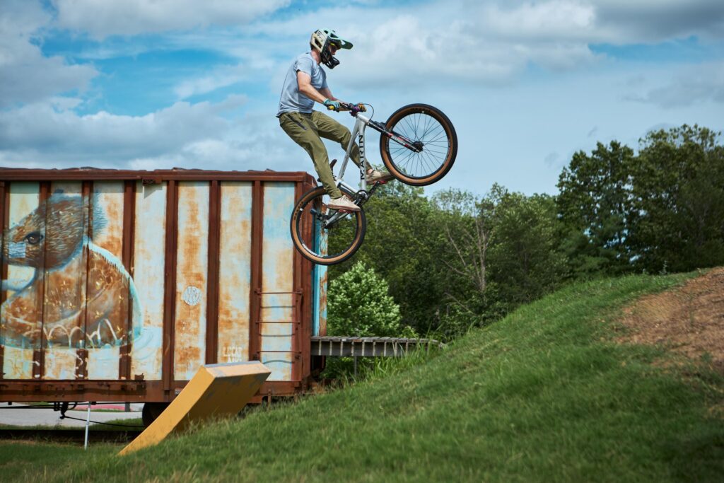 Mountain biker jumping a ramp at the Railyard Bike Park in downtown Rogers