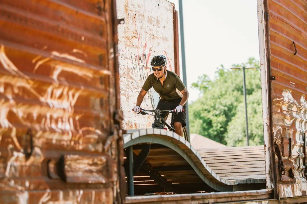 Rider on the boxcar feature at The Railyard Bike Park in downtown Rogers, Arkansas